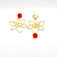 Boucles d’oreilles coquelicot asymétriques en laiton et rouges