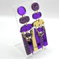 Paire de boucles d’oreilles asymétriques violet à paillettes 